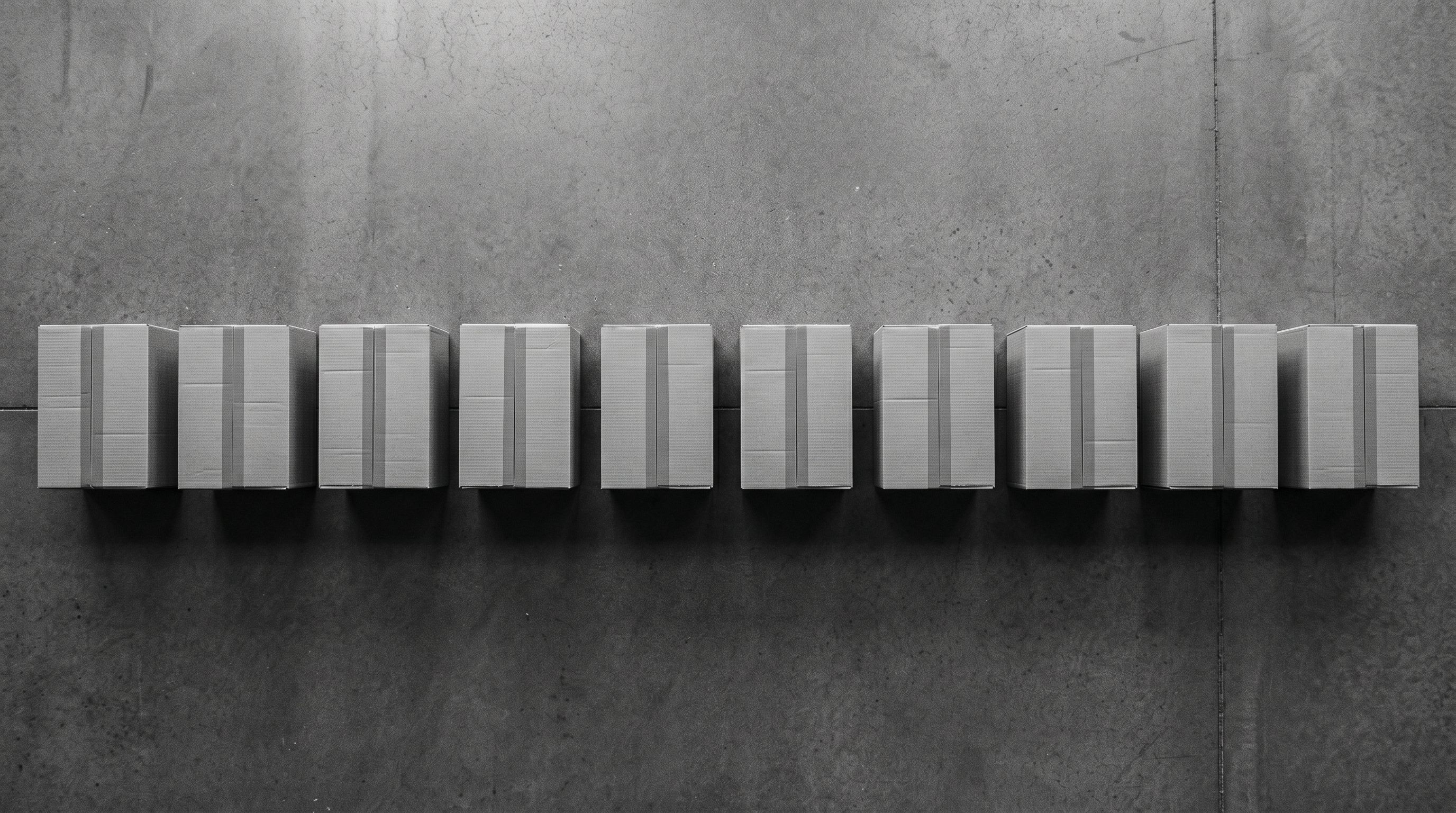 Row of shipping parcels lined up in an organised queue ready for dispatch.