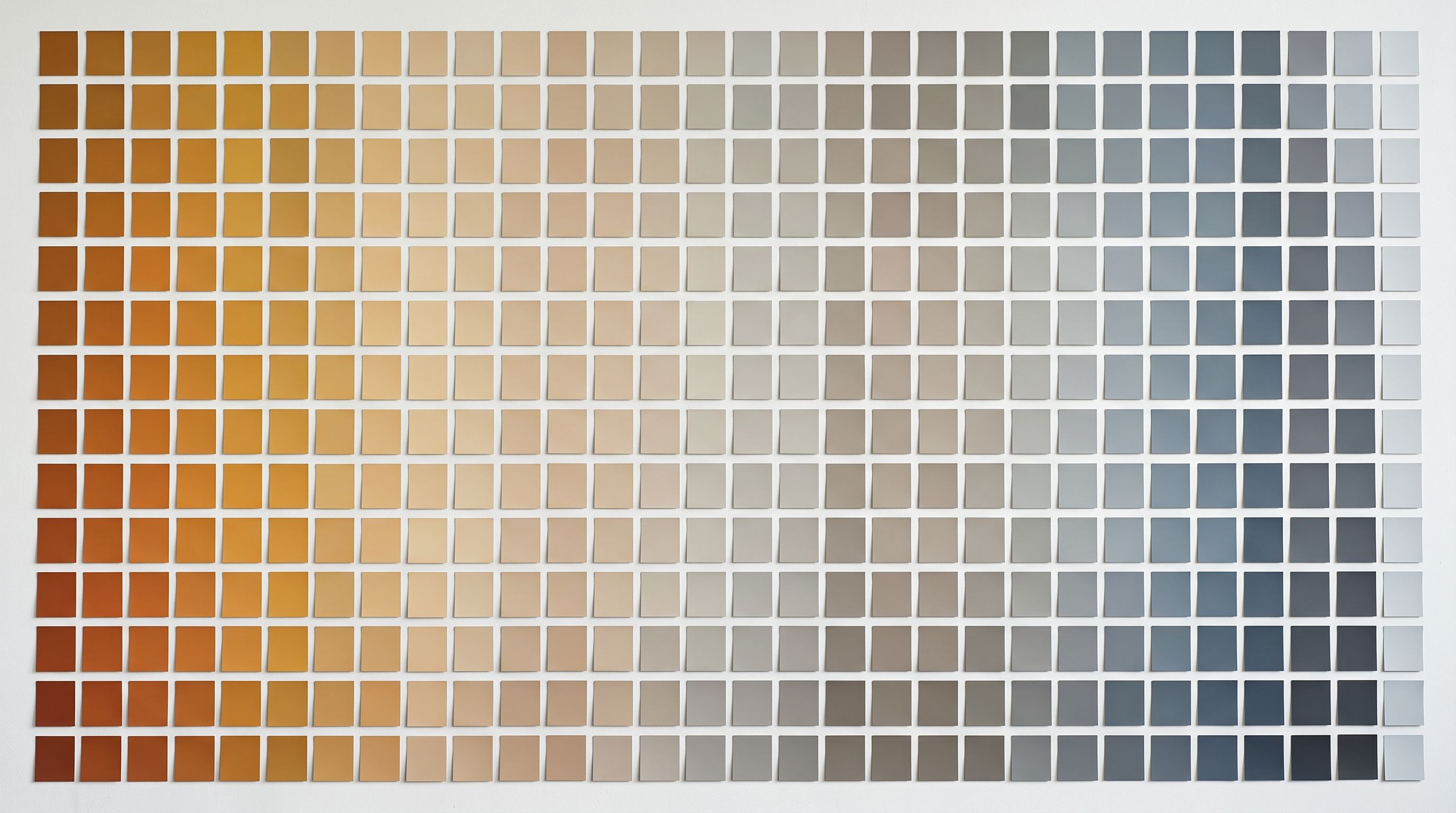 Grid of paint colour swatches arranged from warm ochre to cool slate on white wall.