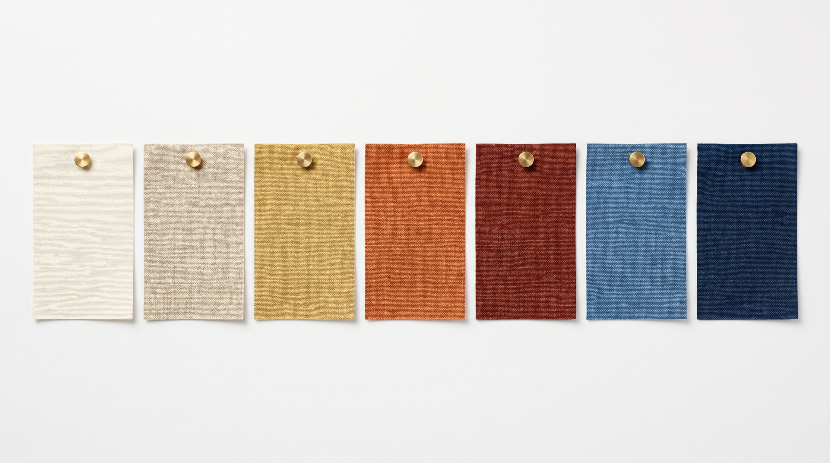 Close-up of product variant colour swatches laid out in a row on a white surface, each tagged with a label.
